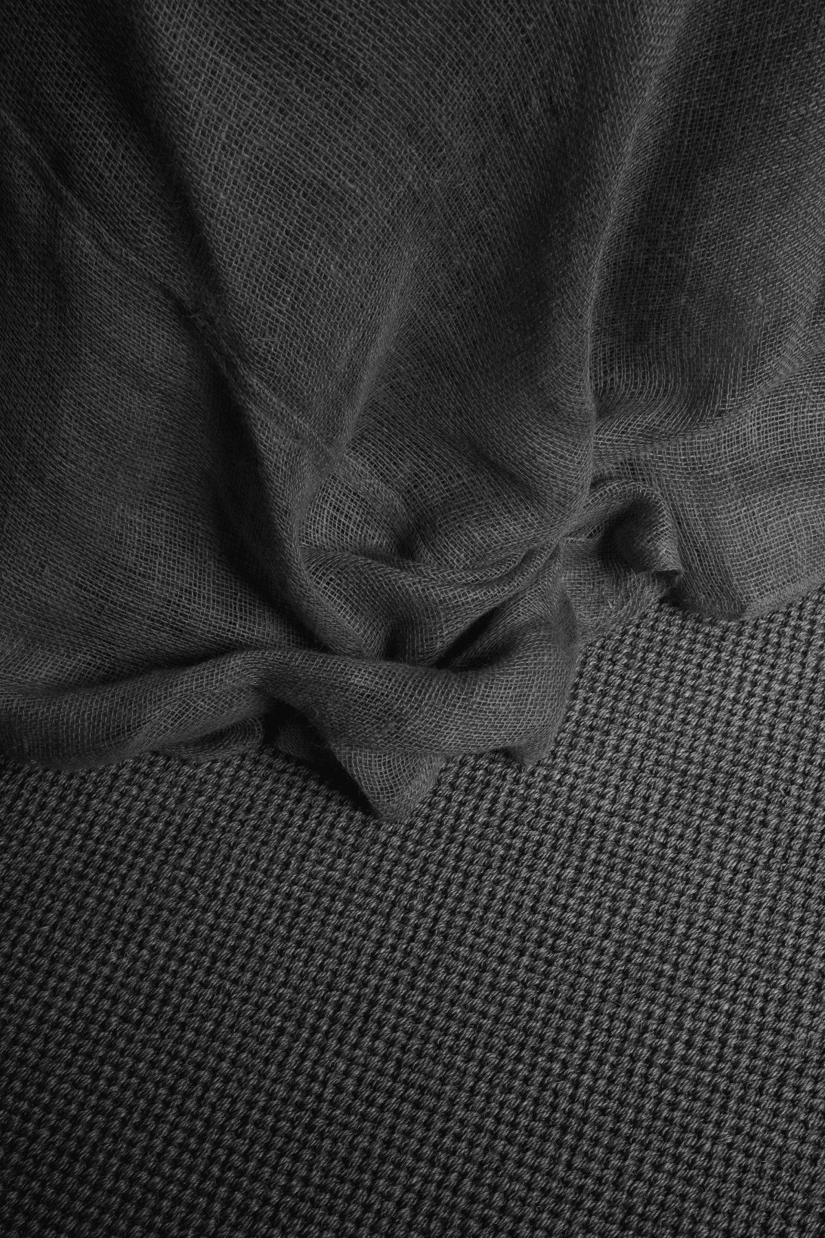 Detailed view of two fabrics. One is a tablecloth and the other is a floor covering. The location is a country house near Looe in Cornwall.