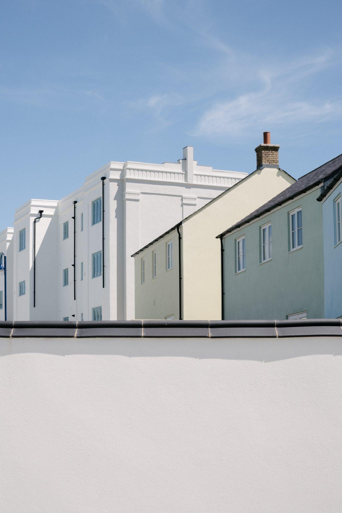 View over a wall towards buildings in Nansledan, Newquay, Cornwall