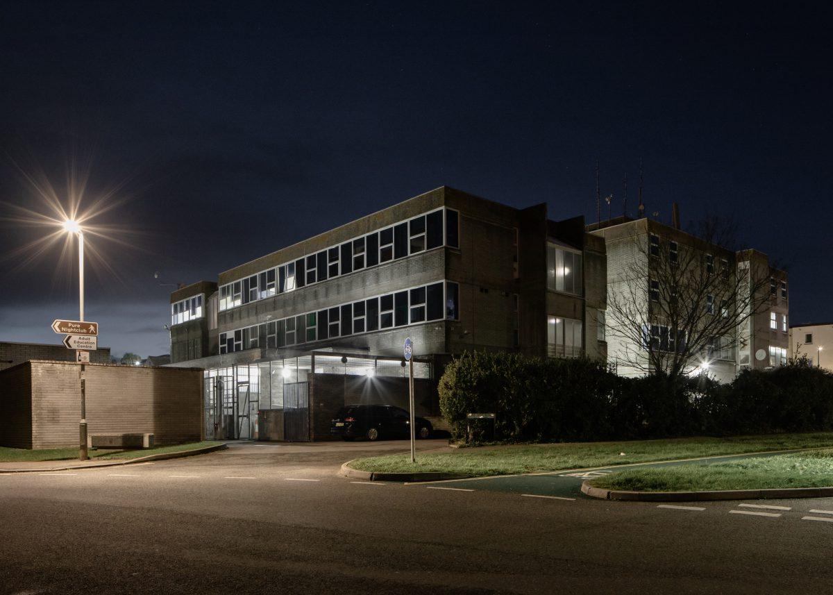 Photographed at night, the brutalist architecture of Newquay Poilce Station, Cornwall.