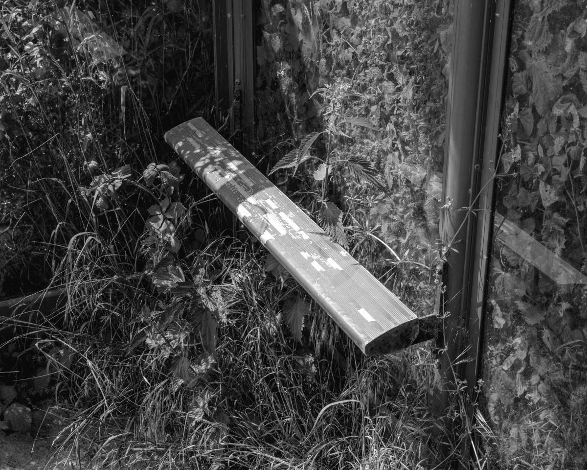 A detailed view inside of bus stop located on a busy road in Dorset.