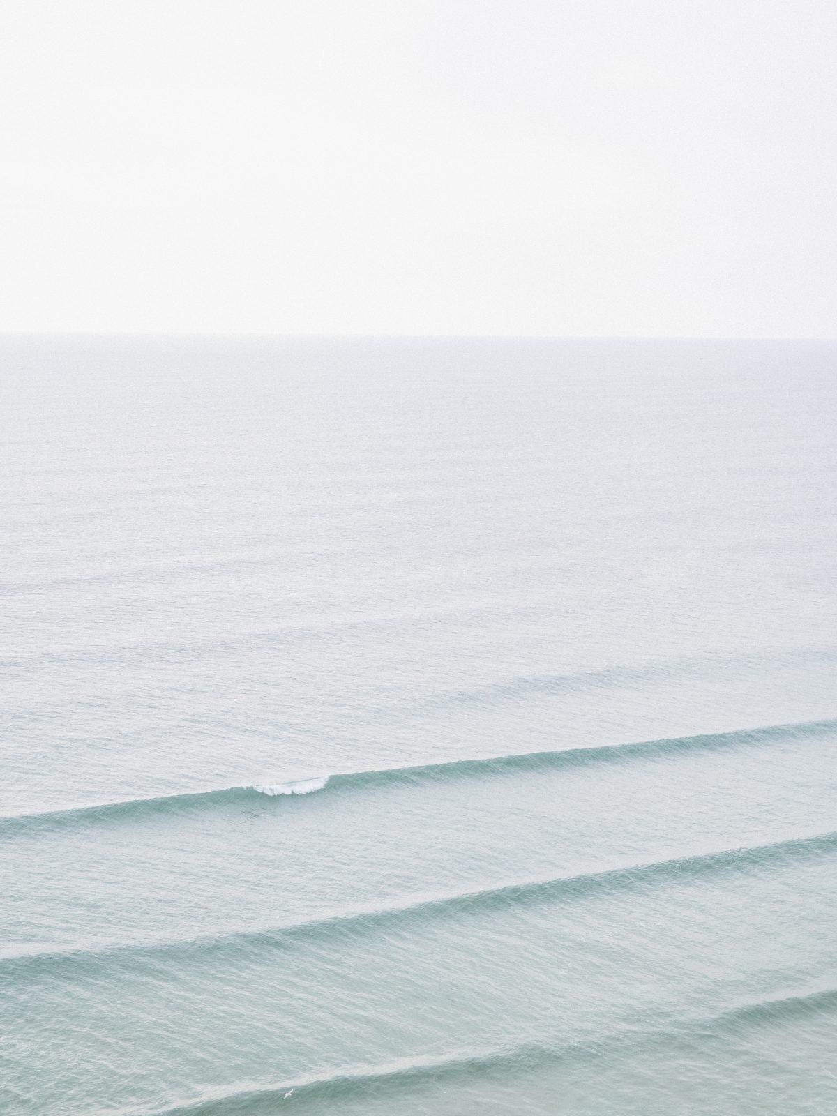 Minimal subject. High key image of the sea with small wave in Newquay, Cornwall.