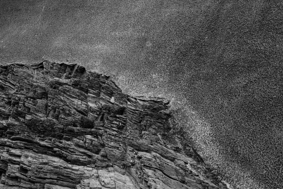 An image of a natural rock formation that's been covered by poured concrete. Split Beach, St Austell.